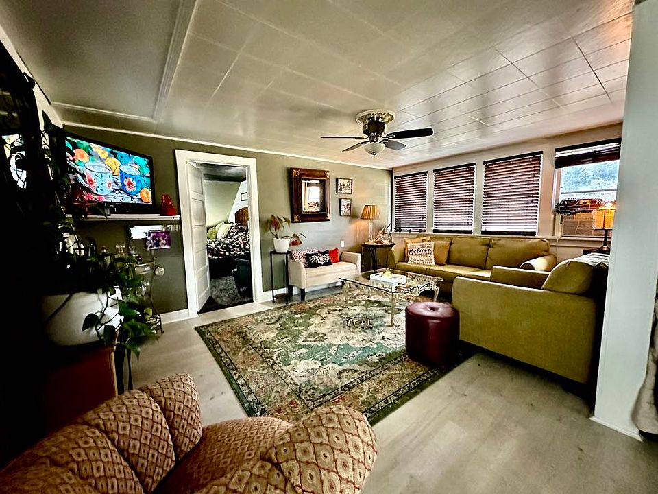 Looking from the kitchen into the living room with the bedroom beyond