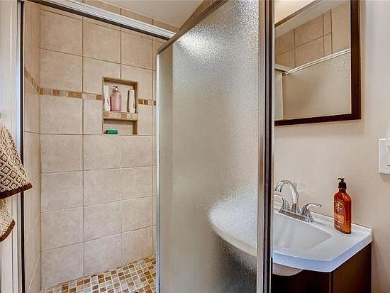 Private bathroom with tiled shower.