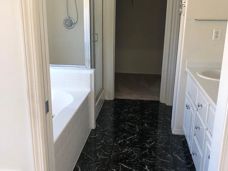 Primary bathroom/on-suite with dedicated toilet room, double sink and jetted tub.