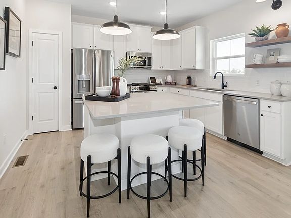 Kitchen with pendant lighting and floating shelves