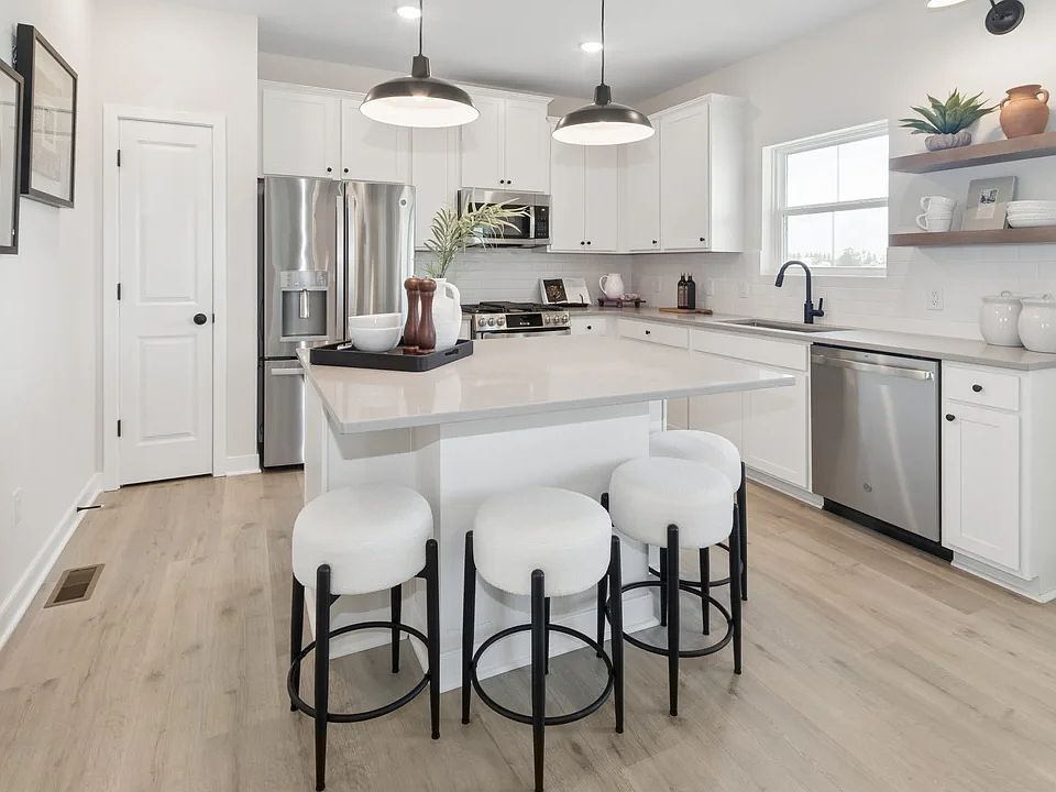Kitchen with pendant lighting and floating shelves