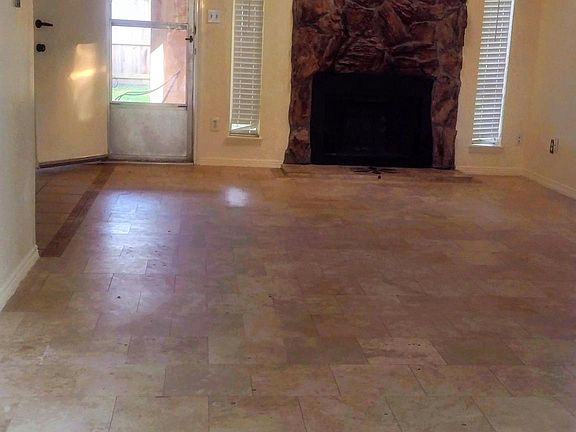 Living room, all tiled, wood chimney.