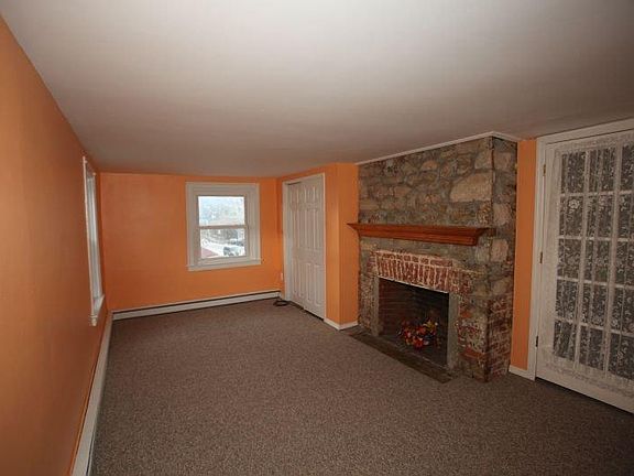 Master Bedroom with ornamental fireplace and closet