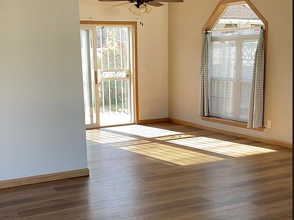 Entering into living area looking toward dining area and back sliding doors.