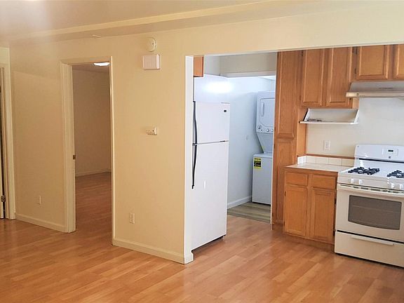 Kitchen with gas stove and fridge. Washer-dryer located in front bathroom.