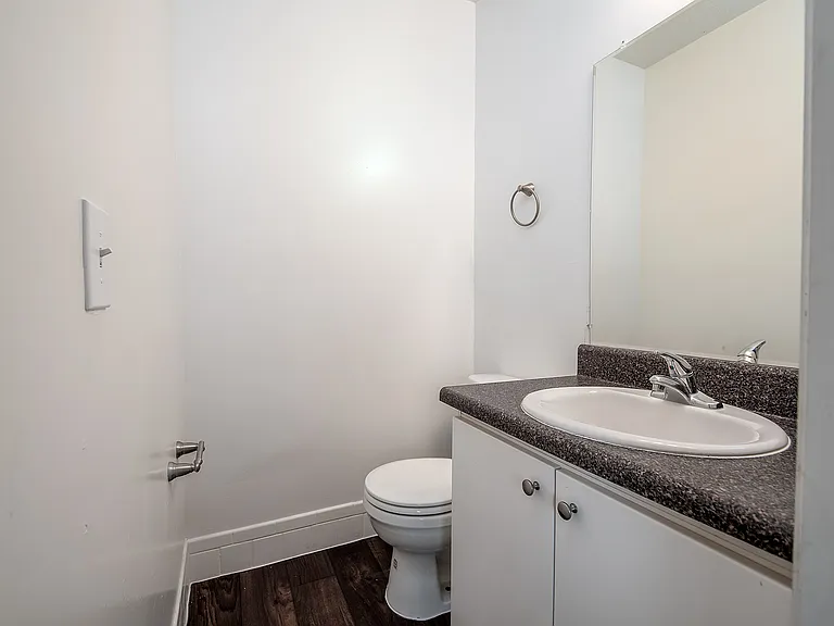Modern bathroom with sleek sink, stylish vanity, and gleaming fixtures, perfect for a minimalist lifestyle.