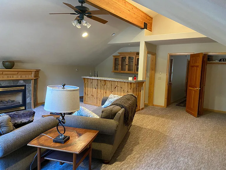 Huge game room with queen murphy bed, twin bed two couches, and wet bar