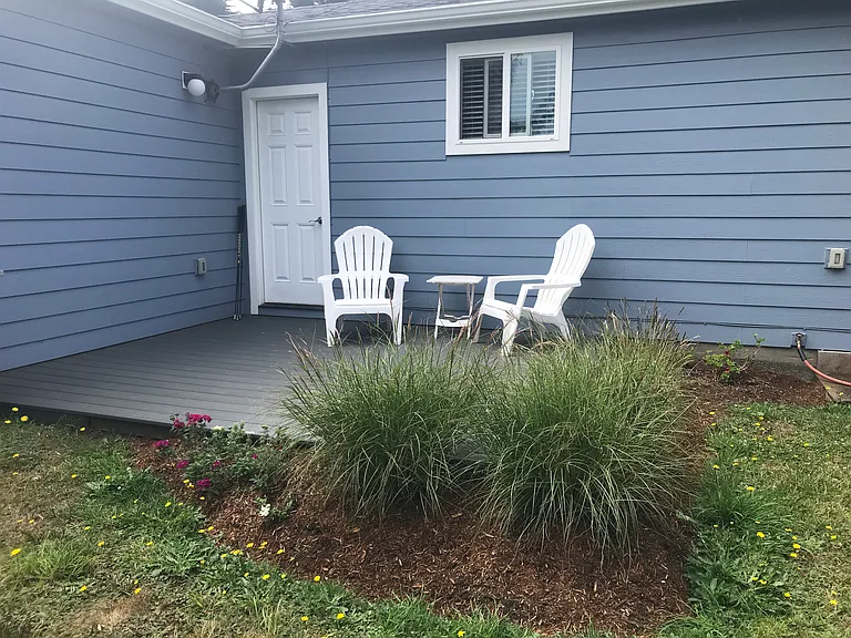Lovely deck and area for barbecue. Very large yard with big trees and room for vegetable gardening or backyard sports.