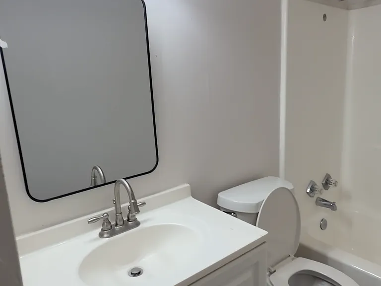 Updated vanity with bright lighting and a clean mirror setup - fresh, simple, and ready to use.