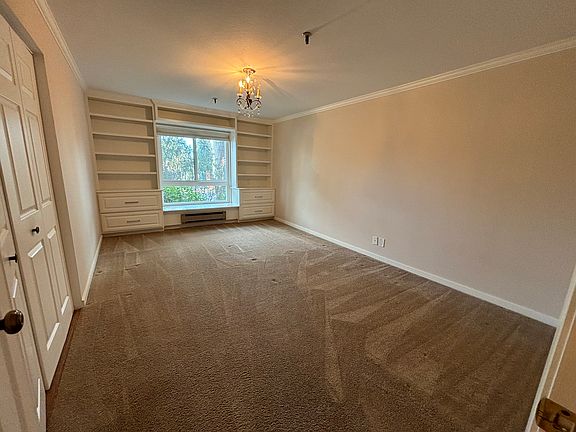 Primary Bedroom with closet to your left and storage along the window