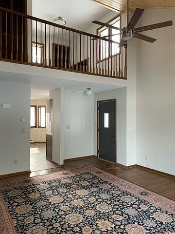 Main living area with view of loft, kitchen, and private entry.