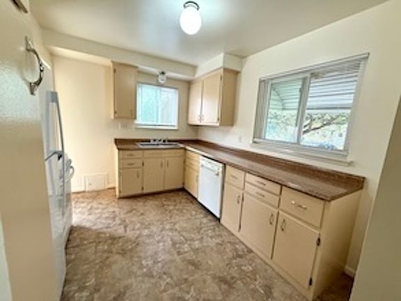 Fridge, gas stove, dishwasher, tons of storage, ample counter space and fresh paint in the kitchen