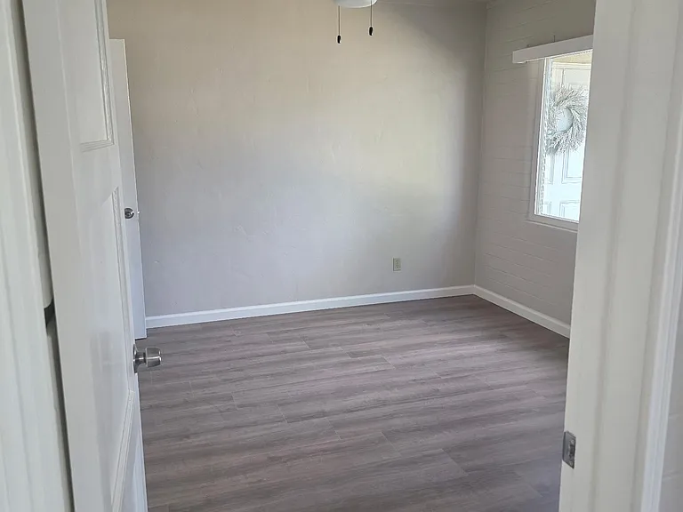 Bedroom with new ceiling fan, closet, andvinyl flooring