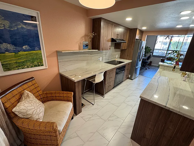 View of kitchen with external window to your back.
