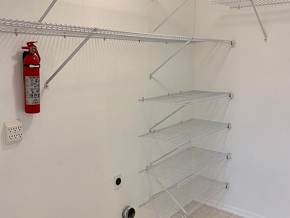 Large laundry space with plenty of additional storage.