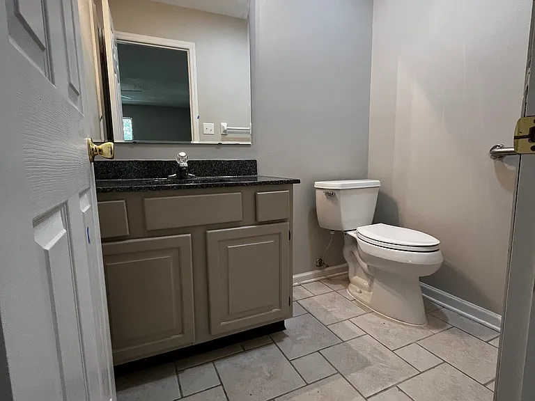 first bedroom with an en suite 1/2 bath