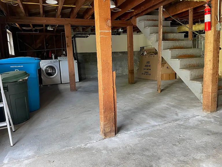 Full basement with washer/dryer and a garage door that opens onto the street for easy access.