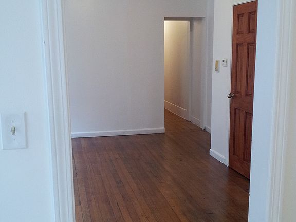 Living room view of hallway, entrance & bathroom