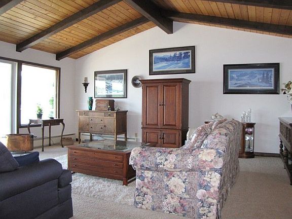 Another view of the living room with large sliding doors to deck running the length of the home.