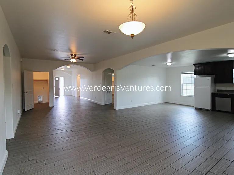 A spacious, open_concept layout connecting the kitchen, living, and dining areas.