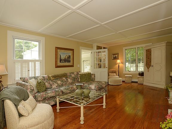 Large living room with gorgeous wood floors, built ins and l