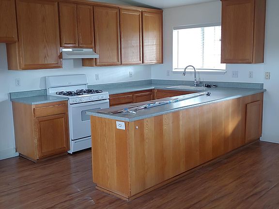 Kitchen includes stove, dishwasher, garbage disposal.