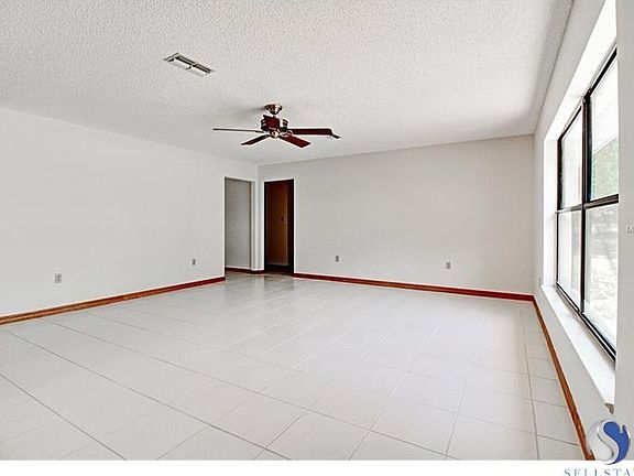 Large Living Room with Neutral Ceramic Tile, Freshly Painted