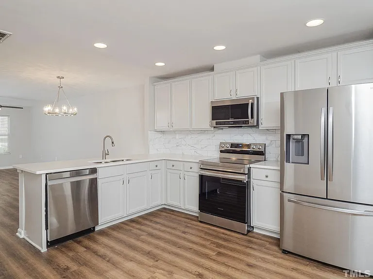 Welcome to your stunning kitchen! Completed with a garbage disposal, matching stainless steel appliances, and recently renovated countertop and backsplash.