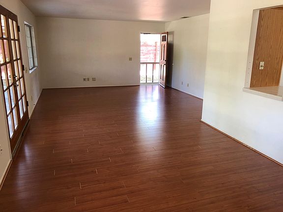 Living room and dining room with kitchen pass through. Hardwood floors throughout with carpeted master and second bedroom.