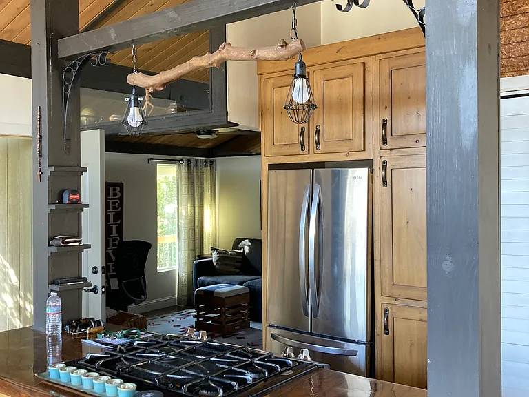 Gas stove/in kitchen washer/dryer. Custom Cabinets, live edge custom wood counters.