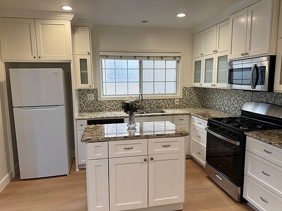 The kitchen looks clean and airy