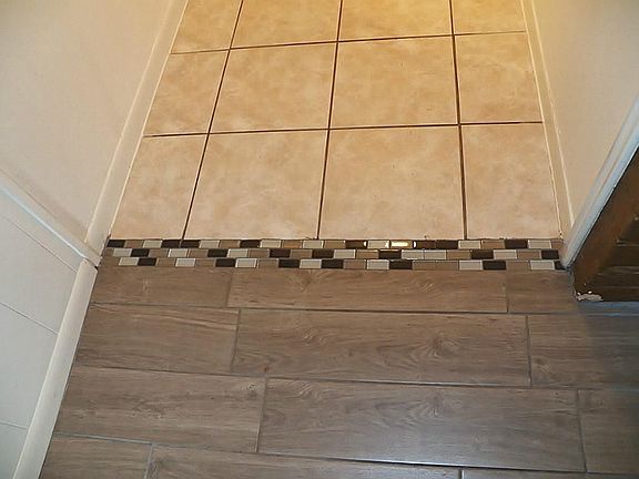 Note the transitional tile detail between the family room and hallway.