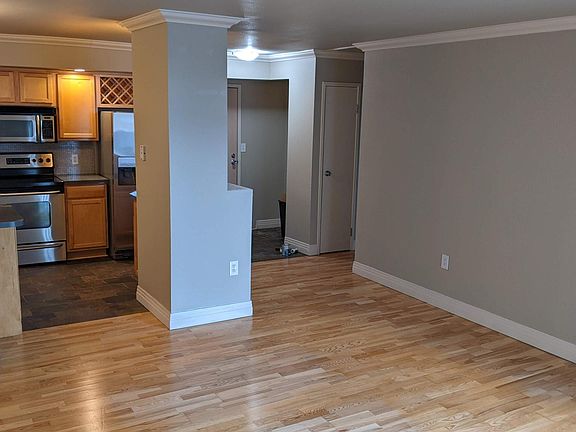 Living Room: open floorplan w/ access to kitchen, entry and balcony