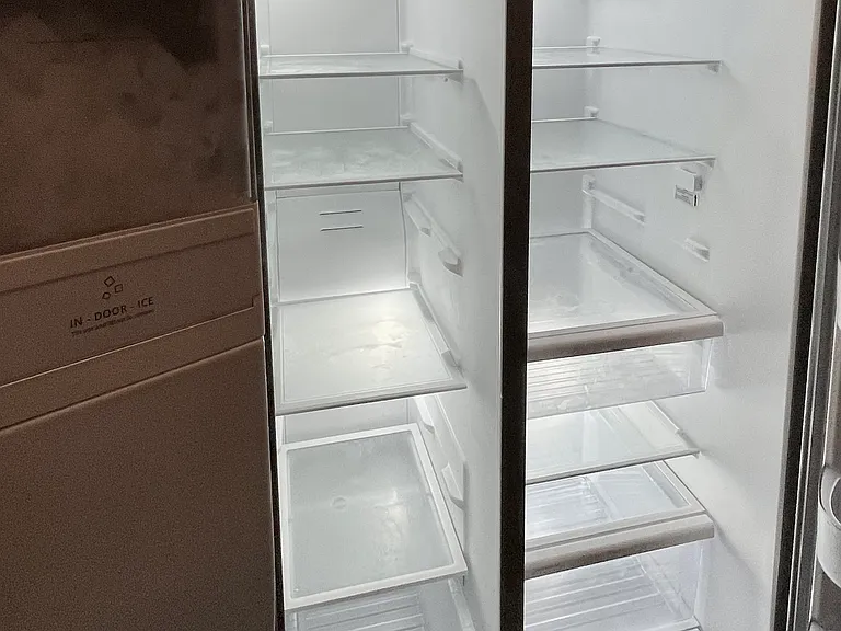 The double door refrigerator with ice maker and water dispensers in the door.