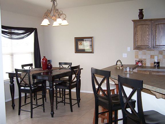Breakfast nook is also spacious and opens to covered back porch.