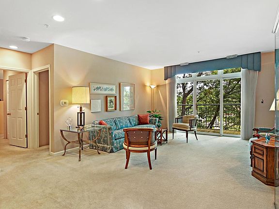 Neutral carpet and so much light from patio doors create a feeling of space for cozy evenings at hom