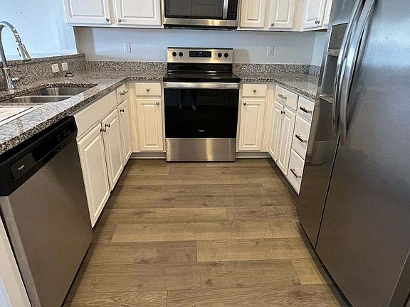 Kitchen with granite counters and applicances
