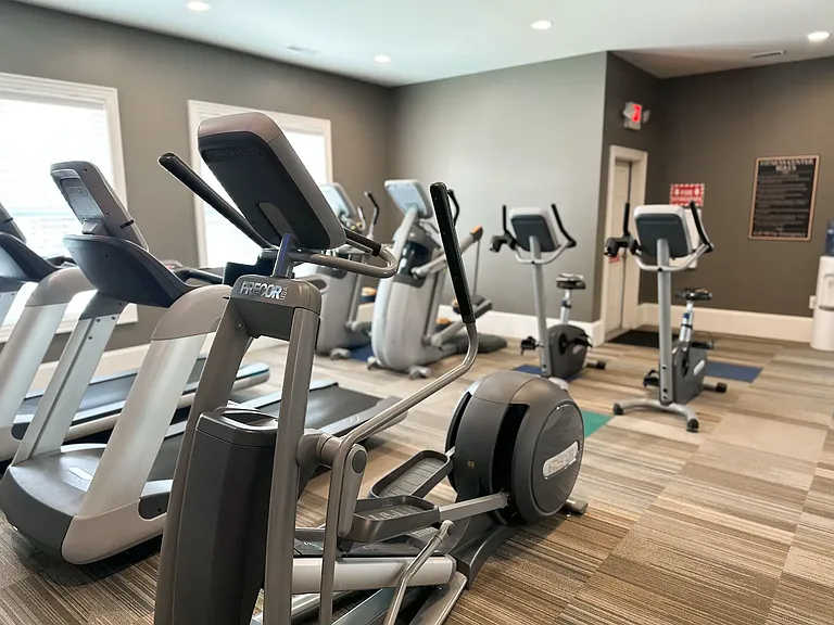 Shown here, is the 24-hour fitness center equipped with multiple cardio fitness machines.
