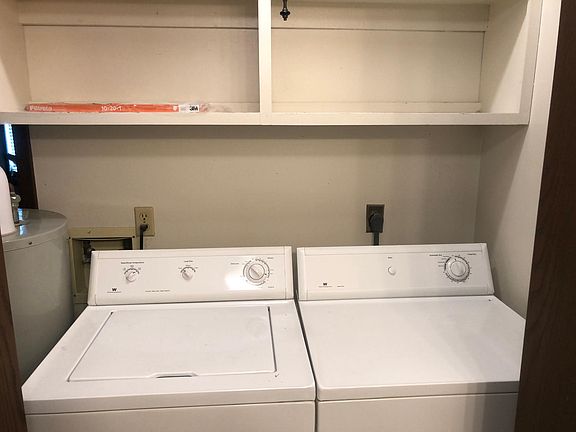 Washer and dryer behind folding doors.