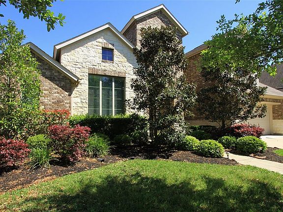 Beautiful landscaping surrounds the front exterior for great curb appeal and a welcoming entrance.