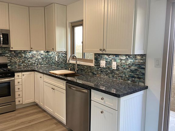 Gourmet kitchen looks out over private backyard area