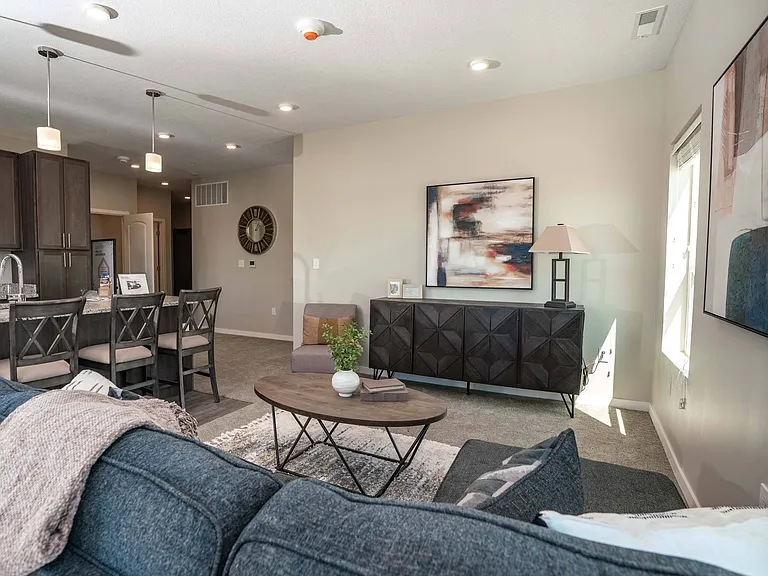 Living room with kitchen view at Heartland Flats Alliance.