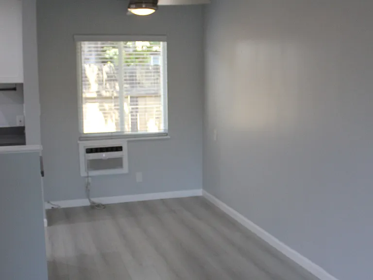 Looking from Living Room toward the Dining area. AC unit and Ceiling Fan for added comfort