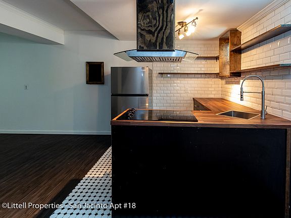 View of kitchen with full sized refrigerator.