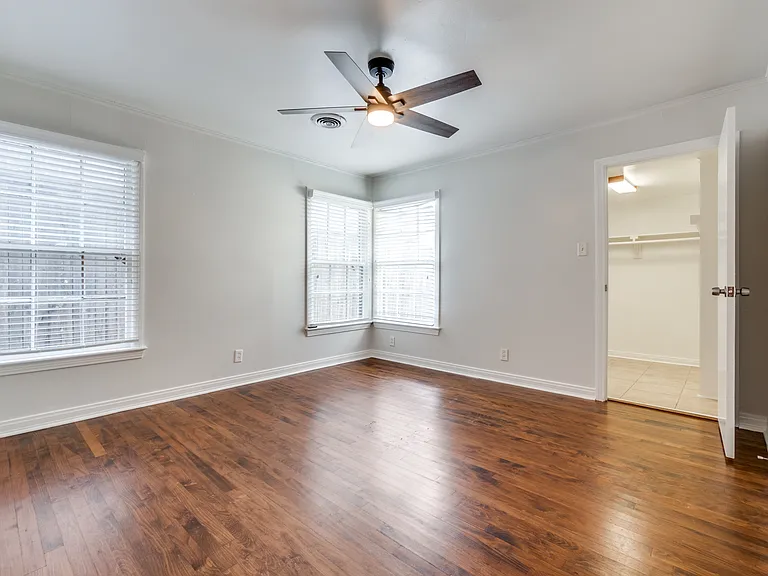 Primary bedroom with walk-in closet faces the backyard