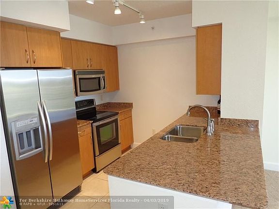 Kitchen with granite counters and stainless appliances.