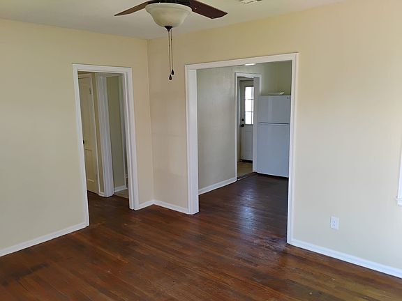 View in living room to dining room on right and hallway on left
