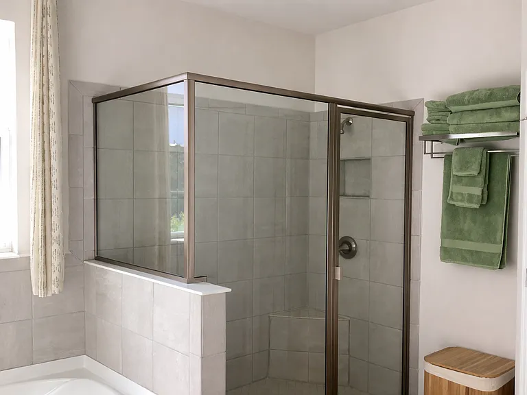 "Walk-in shower with modern tile and glass enclosure"