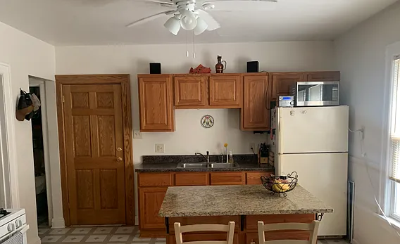 Kitchen with island and ceiling fan