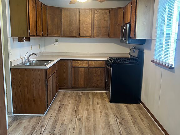 Kitchen with plenty cabinets and updated flooring.